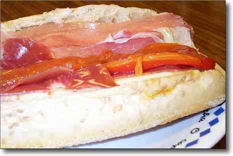 French food and wines sandwiches, prosciutto and sun-dried tomatoes
