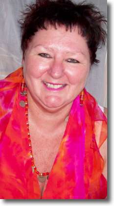 Photo of Teena Hughes March 2009, with handpainted silk in hot pink and orange.
